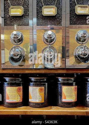 Kaffeebohnen. Wand des Cafés mit 3 etikettierten Kaffeemühlen für Kaffeebohnen. Stockfoto