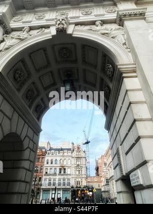 William Silver Frith (1850-1924), Bildhauer. 1908. Steinbogen auf der Charles Street mit Blick auf Whitehall, London SW1, mit dem Red Lion Public House und historischen Gebäuden. Ein Kran ist sichtbar. Stockfoto