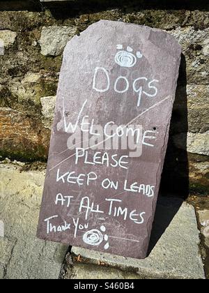 „Dogs Welcome“: Ein handgeschriebenes Schild lädt Hunde und ihre Besitzer ein… Solange sie immer eine Spur haben. Stockfoto