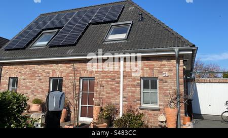 Haus mit Solarpaneelen und Ladestation für Elektrofahrzeuge Stockfoto