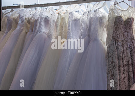 Mit vielen schönen Brautkleider im Showroom stehen. Stockfoto