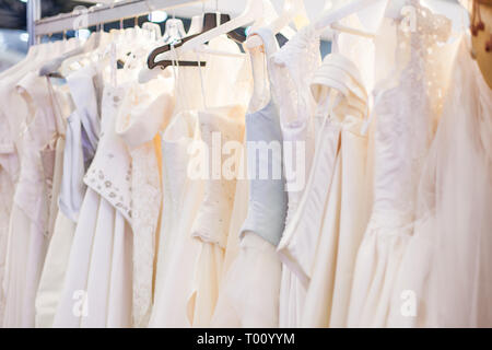 Mit vielen schönen Brautkleider im Showroom stehen. Stockfoto