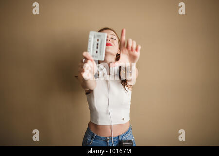 Junge Frau mit weißem retro Hipster audio Kassette. Party 90 s Konzept. Stockfoto