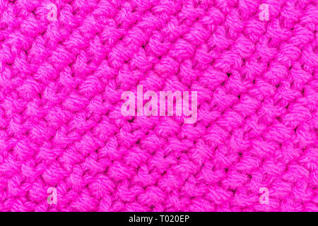 Die Textur des Häkeln, rosa Hintergrund, gemusterten Maschenware Stockfoto