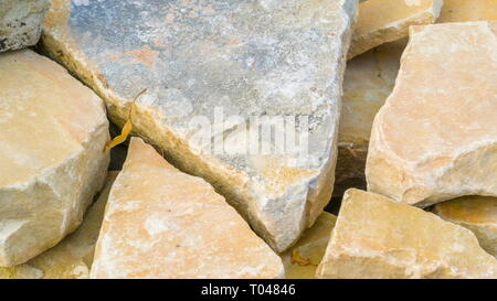 Großer Kalksteinfelsen in verschiedenen Größen auf dem Boden der gelben Steine werden im Zimmer angezeigt. Stockfoto