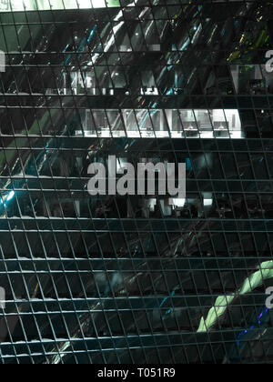 view of modern skyscrapers in business district, light in window of the multi-storey building of glass and steel lighting office close up view Stockfoto