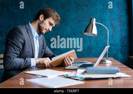 Business Mann im Büro arbeiten mit Laptop und Unterlagen auf seinem Schreibtisch, Berater Rechtsanwalt Konzept. Stockfoto