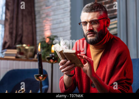 Man Gefühl der Freude und in der Lesung Bücher für Magier beteiligt Stockfoto