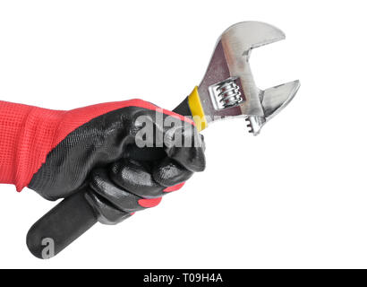 Verstellbarer Schraubenschlüssel in der Hand eines Mannes in einem roten Handschuh arbeiten. Schlüsseldienst Werkzeug. Stockfoto