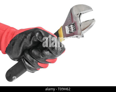 Verstellbarer Schraubenschlüssel in der Hand eines Mannes in einem roten Handschuh arbeiten. Schlüsseldienst Werkzeug. Stockfoto