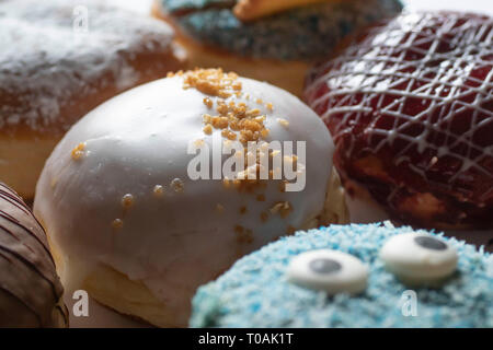 Leckere frisch gebackene Berliner mit verschiedenen Toppings Stockfoto