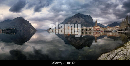 Panorama von Lecco Stadt spiegelt sich auf dem See in einem erstaunlichen bewölkten Tag, Lombardei, Italien Stockfoto