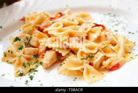 Farfalle Nudeln mit Fisch Stücke aus Porzellan Platte Stockfoto