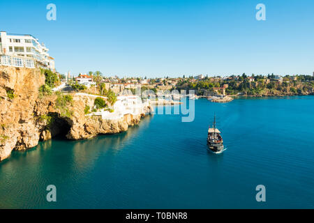 Touristenboot Ansätze der Eingang zum Meer Höhle, von Yavuz Ozcan Park mit Hafen im Hintergrund in Antalya, Türkei gesehen. Horizontale Stockfoto