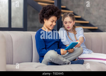 Fröhliche Kinder gemeinsam ansehen Film auf Tablet Stockfoto