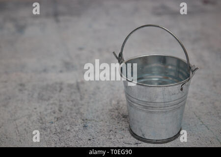 Leere kleine metallene Löffel auf einen konkreten Hintergrund isoliert. kopieren. Stockfoto