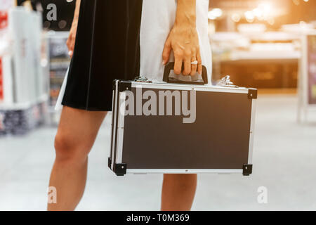 Das Mädchen hält einen kleinen Aluminiumgehäuse Stockfoto