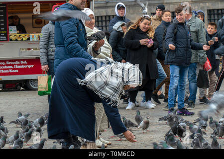 Islamische Frauen die Fütterung der Tauben am Dam Square Amsterdam Die Niederlande 2019 Stockfoto