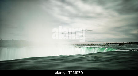 Blick auf die stürzenden Wasser der Horseshoe Falls bei den Niagara Fällen mit Wasser Dampf aus dem kaskadierenden Gewässern Stockfoto