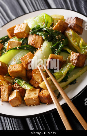 Gebratener Tofu mit Seite an Seite und Sesamsamen close-up auf einem Teller. Vertikale Stockfoto