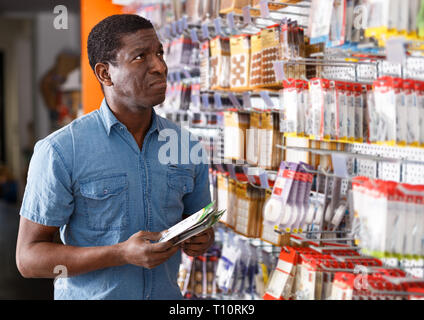 Erfahrene African American foreman für Lieferungen auf der Suche nach Renovierungsarbeiten in Gebäude SB-Warenhaus. Stockfoto