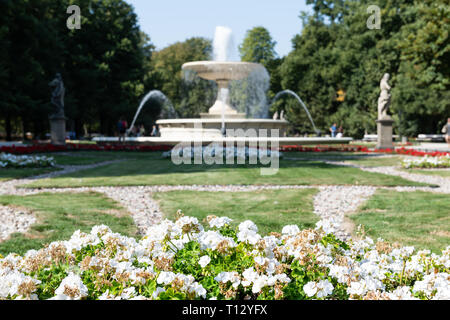 Warschau, Polen Touristen durch Brunnen im Sommer Saxon Gardens Park mit Spritzen spritzen Skulpturen und flower bed Stockfoto