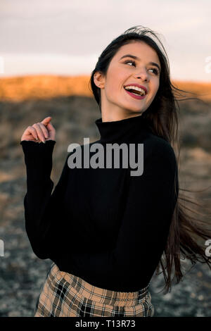 Portrait von Lachen teenage Mädchen mit schwarzen Pullover im Freien Stockfoto