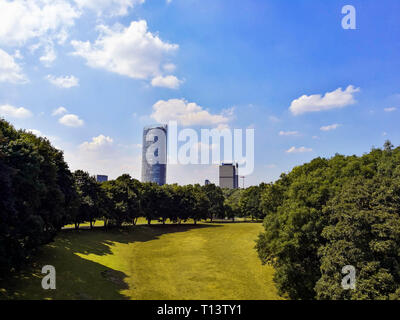 Ansicht der Post Tower, DHL-Zentrale in Bonn, Deutschland, inmitten der Bäume der Freizeitpark Rheinaue, 19. Juli 2018. Parks in Bonn, Deutschland. Stockfoto