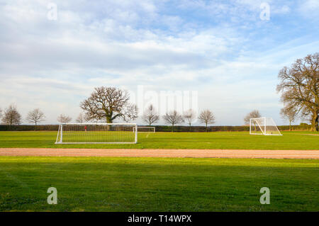 Empty football goalposts in playing fields on a summer morning, Stockfoto