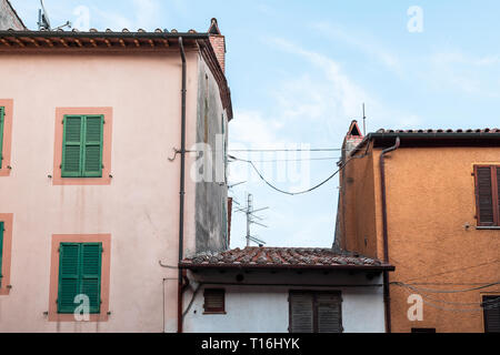 Chiusi, Italien Straße in kleinen mittelalterlichen Stadt Dorf in Umbrien in der Nähe der Toskana Ansicht von Apartment Gebäuden im Sommer Tag mit niemand Rosa ora Stockfoto