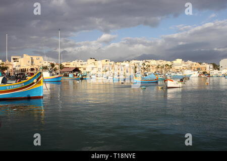 Marsaxlokk, Malta - Januar 21, 2018: Luzzu in Malta verankert, im Hafen von Marsaxlokk, einem traditionellen Fischerdorf in Malta. Ein luzzu ist ein Tradit Stockfoto
