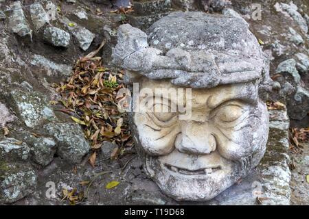 Alter Mann Kopf geschnitzt aus Stein in weltberühmten Ruinen von Copan Ausgrabungsstätte der alten Maya-Zivilisation, ein UNESCO-Weltkulturerbe in Honduras Stockfoto