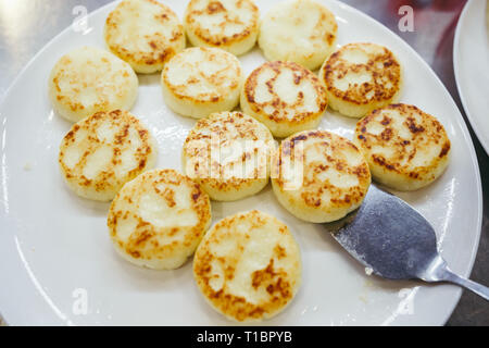 Eine große Platte mit Quark zum Frühstück, Quark, Pfannkuchen, Quark Krapfen mit frischen Beeren Erdbeeren mit Daisy Flowers Stockfoto