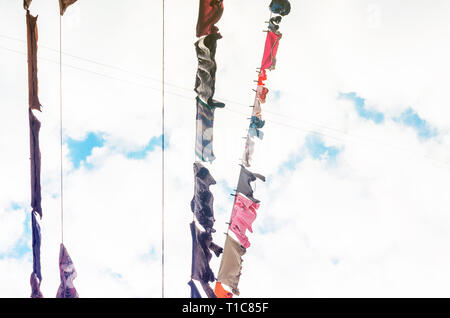 Die Bettwäsche ist auf der Wäscheleine auf dem Hintergrund der blauen Himmel mit Wolken getrocknet. Sonnigen Tag Stockfoto