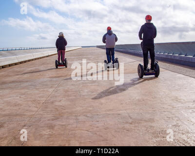 Drei Freunde auf Segways auf dem freien lange Straße, Platz kopieren Stockfoto