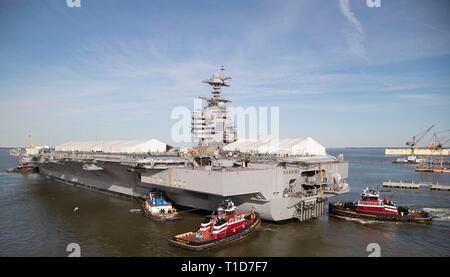 NEWPORT NEWS, Virginia (17. März 2019) USS Gerald R. Ford (CVN 78) manövriert, die von Schleppern in den James River bei Ford's drehen Schiff Evolution. Ford wird derzeit in post-shakedown Verfügbarkeit Huntington Ingalls Industries-Newport Nachrichten Schiffbau. (U.S. Marine Foto von Mass Communication Specialist 3. Klasse Brett Walker) Stockfoto