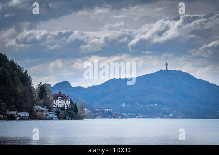 Panoramablick vom Strand über Klagenfurt Wörthersee durch kleine Dorf Maiernigg zu Berg Pyramidenkogel mit Turm Stockfoto