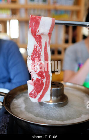 Rindfleisch mit einem Essstäbchen Stockfoto