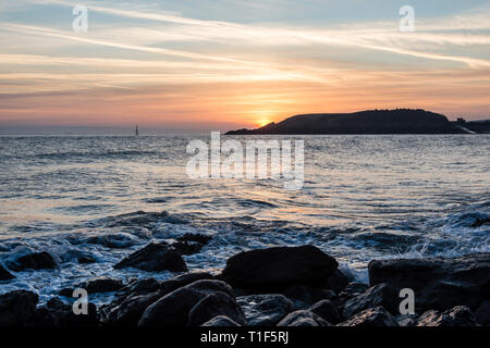 Eine ruhige Sonnenuntergang über dem Meer und die Silhouette Landspitze von kalten Knap Punkt, Barry, South Wales Stockfoto
