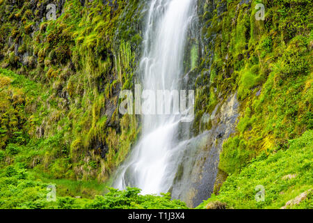 Kleiner Wasserfall closeup von Seljalandsfoss, Island mit weißen Wasser von Klippe lange Belichtung in Grün bemoosten Sommer felsige Landschaft Stockfoto