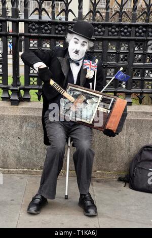 Westminster, London, Großbritannien. 27. Mär 2019. Bleiben Demonstrant. Ein Charlie Chaplin Schauspieler Breie" einen TV-Bildschirm mit einem Hammer Brexit gekennzeichnet. Houses of Parliament, Westminster, London. UK Credit: michael Melia/Alamy leben Nachrichten Stockfoto