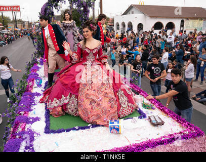 Lokale Debütantinnen und ihre Begleitpersonen tragen aufwendigen Kostümen, beim Reiten auf einem Float bei Washington's Birthday Celebration Parade in Laredo, TX USA Stockfoto