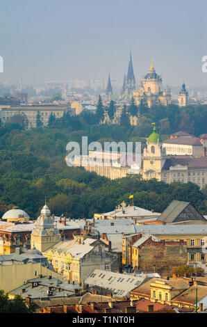 Lemberg, Ukraine - 1. September 2018: Nebligen Morgen in der Innenstadt von Rathausturm. Dächer der alten Stadt. Blick auf die Kirche der Hll. Olha und Stockfoto