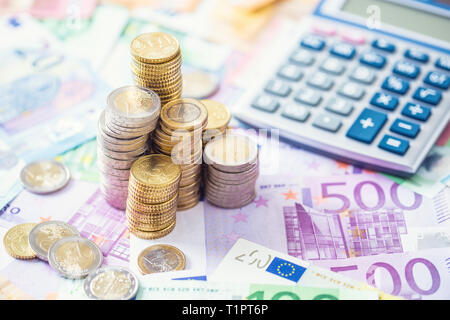 Close-up Euro-Münzen und -Banknoten mit Taschenrechner. Stockfoto