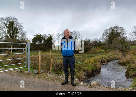 (190328) - Derry, März 28, 2019 (Xinhua) - Brian Renaghan, steht neben der irischen Grenze, die seine Farm spaltet sich in zwei, die eine Hälfte in der Grafschaft Armagh in Nordirland im Vereinigten Königreich und das andere in der Grafschaft Monaghan in der Republik Irland am 19. März 2019. Die sich abzeichnende Möglichkeit einer harten irischen Grenze, die von Brexit Ursachen Qual zu Menschen in Derry, eine Grenzstadt in Nordirland noch nicht vertraut mit dunklen Tagen von Spaltung und Gewalt erstellt werden konnte. Mit Spotlight: Nordirland Stadt vorsichtig von möglich, die Grenze als Brexit Webstühle (Xinhua/Han Yan) Stockfoto