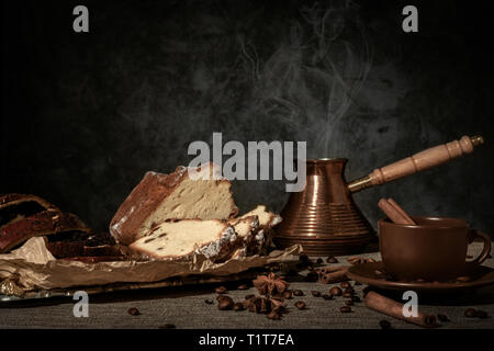 Frisch gemahlenen Kaffee in einen Türken auf einem hölzernen Hintergrund gebraut Stockfoto