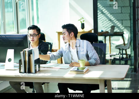 Zwei jungen asiatischen Geschäft Leute zusammen arbeiten im Büro über Business Desktop Computer. Stockfoto