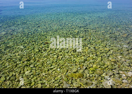Crystal transparent türkis Meerwasser mit gelben Steinen in den flachen Stockfoto