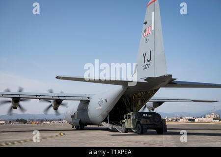 Das bodenpersonal mit der 36Th Airlift Squadron ein Humvee Last auf der C-130 J Super Hercules während der YOKOTA C-130J Rodeo März 22, 2019, Yokota Air Base, Japan. Der Wettbewerb demonstriert verschiedene Kampf-Funktionen und Standards der C-130 Flugzeugbesatzungen. (U.S. Air Force Foto von älteren Flieger Donald Hudson) Stockfoto