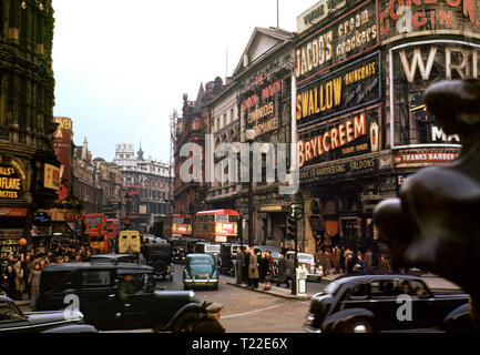 LONDON PICCADILLY 1940er SHAFTESBURY AVENUE ARCHIV 1940er Jahre Vintage-Farbbild der Shaftesbury Avenue voller Verkehr traditionelle schwarze Taxis und rote Londoner Busse, die vom Piccadilly Circus, London um 1940 aus gesehen wurden Stockfoto